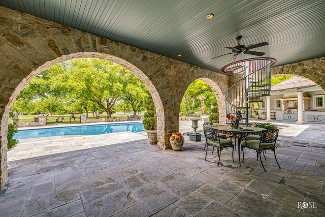 view of patio with area for grilling and ceiling fan