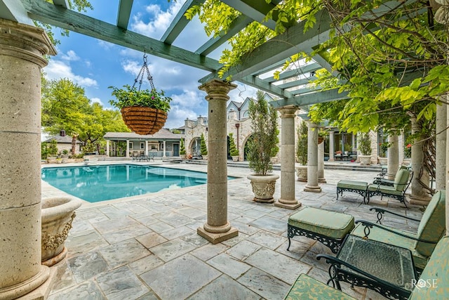 view of pool with a pergola and a patio