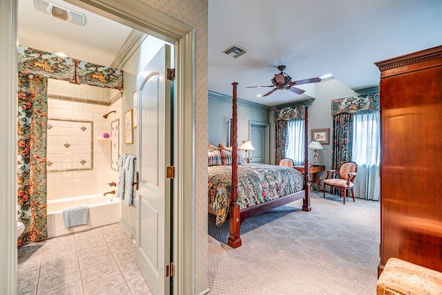 carpeted bedroom featuring ornamental molding, ensuite bathroom, and ceiling fan