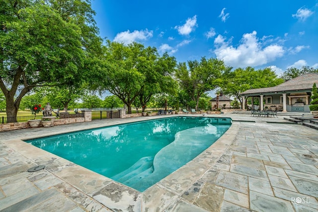 view of swimming pool featuring a patio area