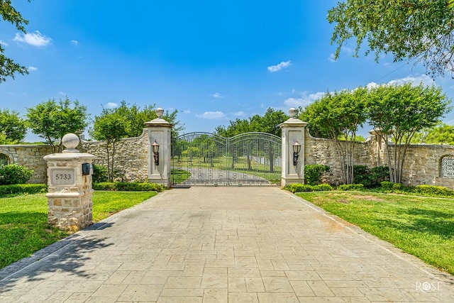 view of gate featuring a yard