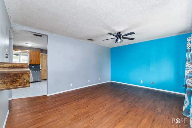 spare room featuring hardwood / wood-style flooring, ceiling fan, and a textured ceiling