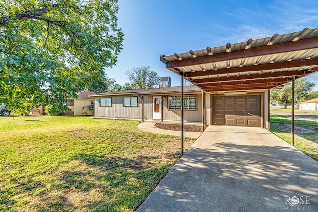 view of front of property featuring a garage, a carport, and a front lawn