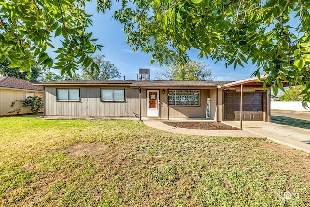 ranch-style home featuring a garage and a front lawn