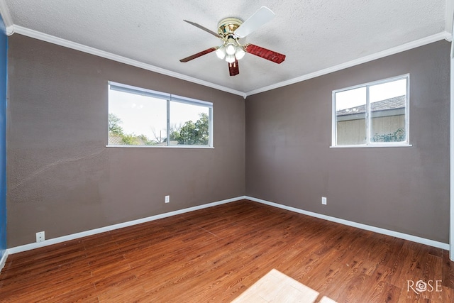 unfurnished room with ceiling fan, ornamental molding, and wood-type flooring