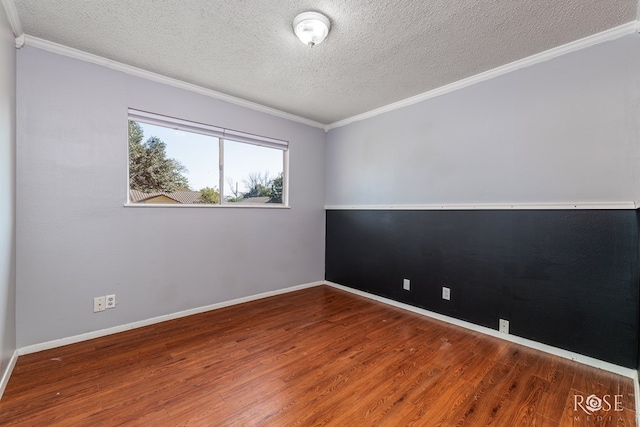 empty room featuring ornamental molding, wood-type flooring, and a textured ceiling