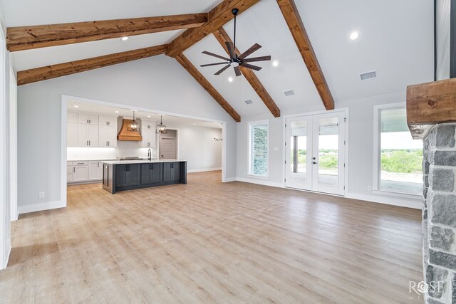 2734 Oak Hills Trl, San Angelo, TX 76904 - unfurnished living room with high vaulted ceiling, beam ceiling, a sink, a ceiling fan, and light wood-style floors