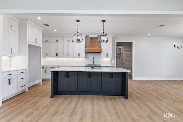 2734 Oak Hills Trl, San Angelo, TX 76904 - kitchen with custom exhaust hood, a chandelier, a sink, backsplash, and recessed lighting