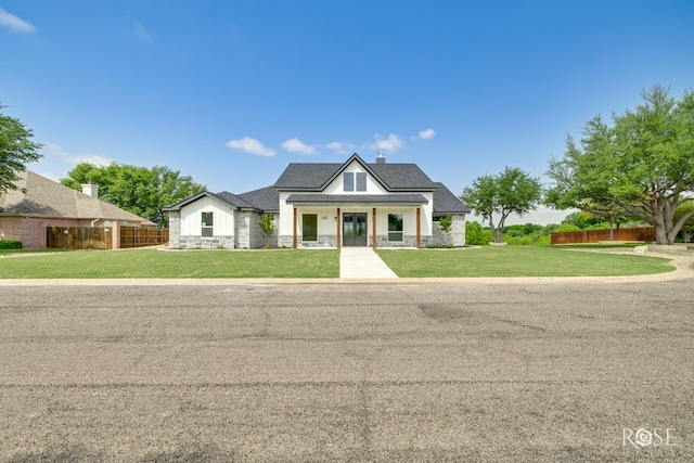 2734 Oak Hills Trl, San Angelo, TX 76904 - modern inspired farmhouse with stone siding, a chimney, and covered porch