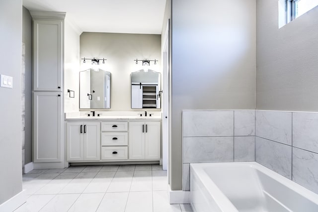 bathroom featuring tile patterned flooring, vanity, and a bathtub