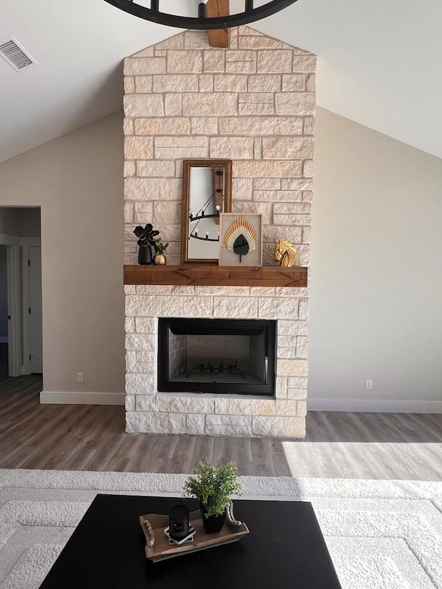 unfurnished living room featuring hardwood / wood-style flooring, a fireplace, and vaulted ceiling