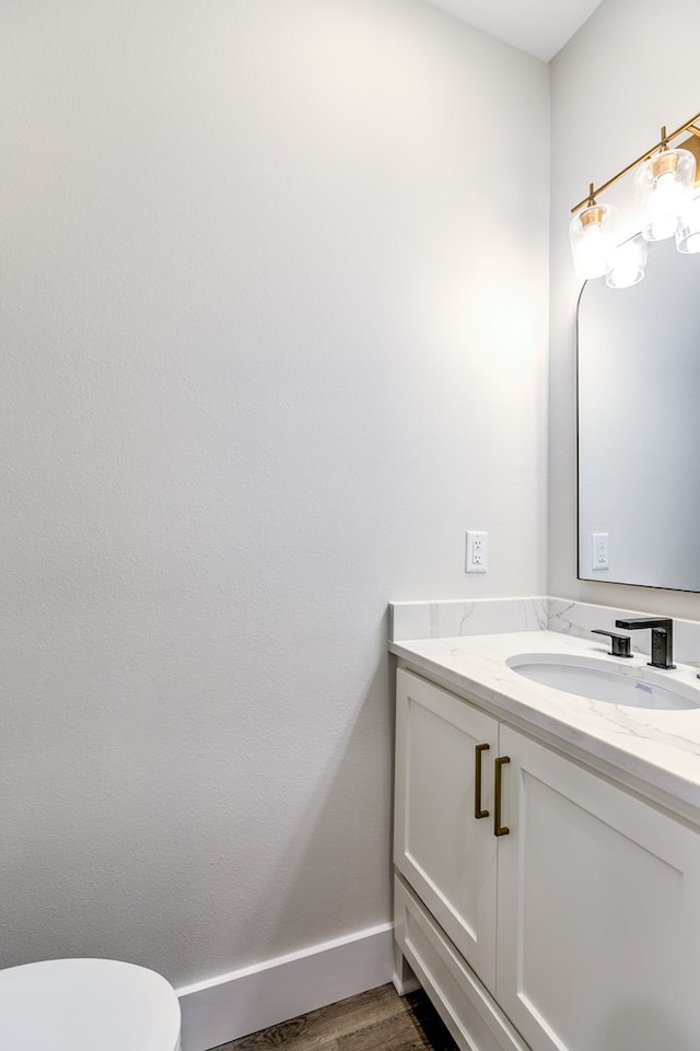 bathroom featuring vanity, toilet, and wood-type flooring