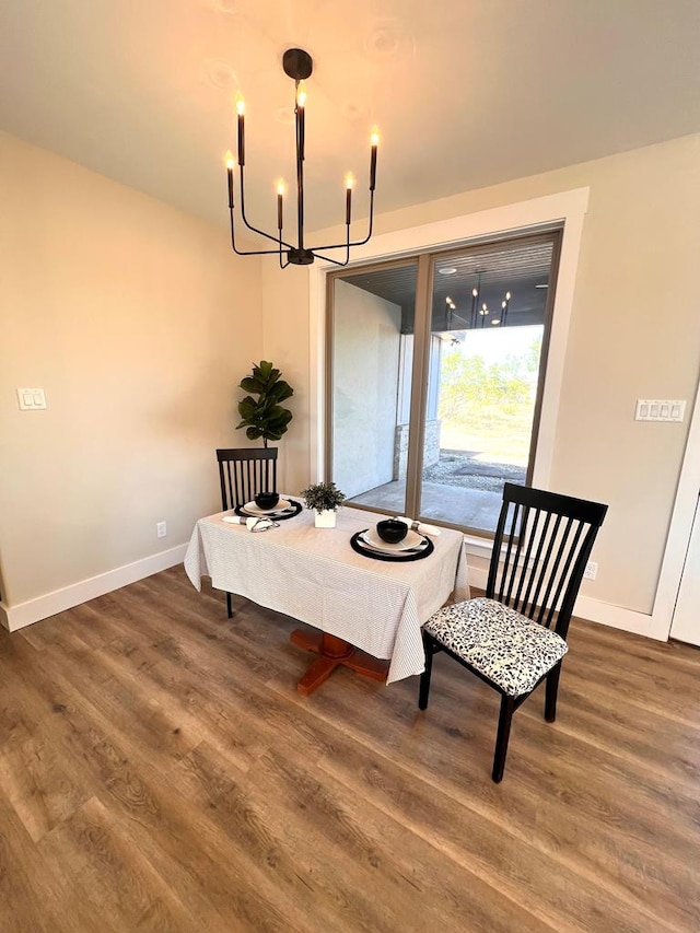 dining space with a chandelier and dark hardwood / wood-style flooring