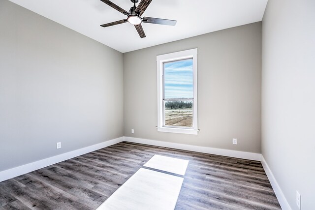 spare room with hardwood / wood-style flooring and ceiling fan