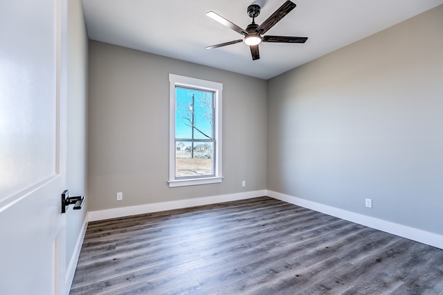 unfurnished room featuring dark wood-type flooring and ceiling fan