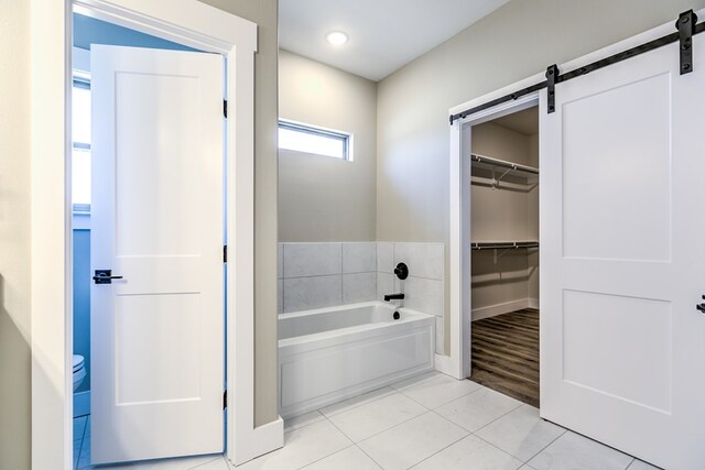 bathroom featuring tile patterned flooring and a washtub