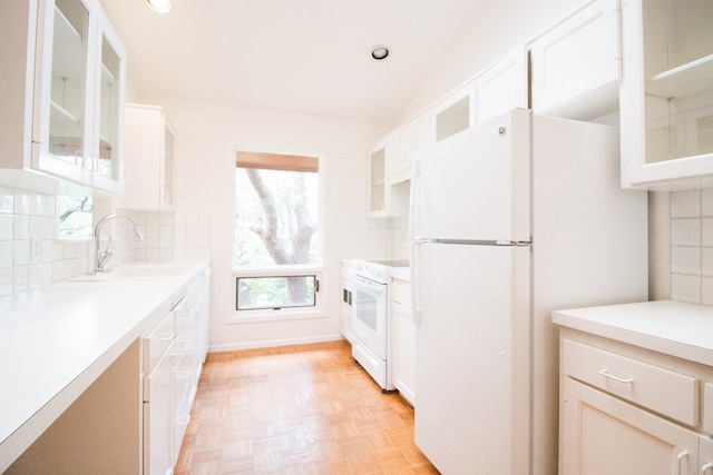 27 Yucca St, San Angelo, TX 76901 - kitchen with white appliances, a sink, light countertops, glass insert cabinets, and vaulted ceiling