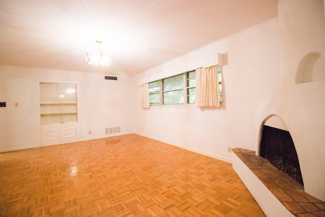 27 Yucca St, San Angelo, TX 76901 - unfurnished living room with a chandelier, a tile fireplace, and baseboards