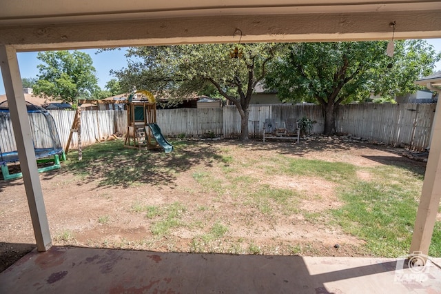 3709 Tridens Trl, San Angelo, TX 76904 - fenced backyard with a trampoline and a playground