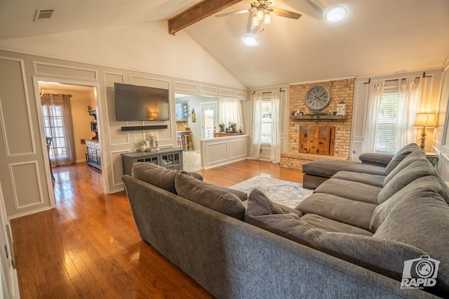 3709 Tridens Trl, San Angelo, TX 76904 - living area with a decorative wall, beamed ceiling, a ceiling fan, wood finished floors, and high vaulted ceiling