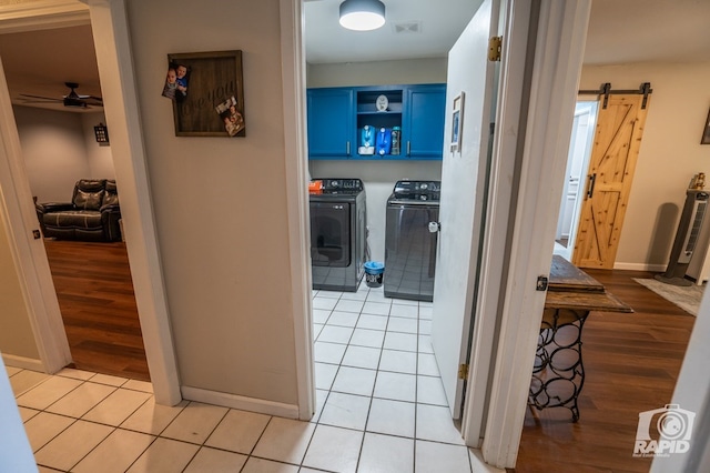 3709 Tridens Trl, San Angelo, TX 76904 - corridor with a barn door, washing machine and clothes dryer, and light wood-type flooring