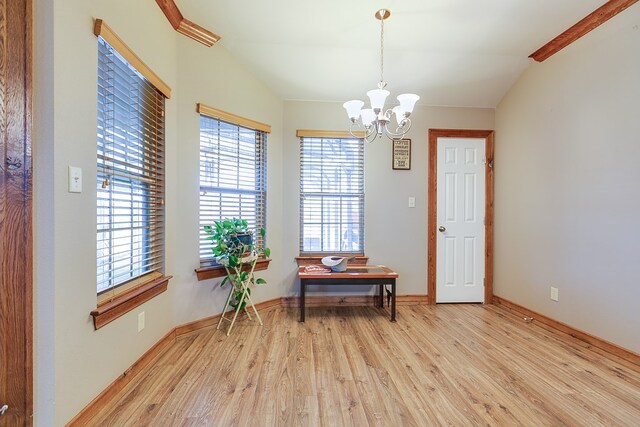 interior space featuring vaulted ceiling, an inviting chandelier, and light wood-type flooring