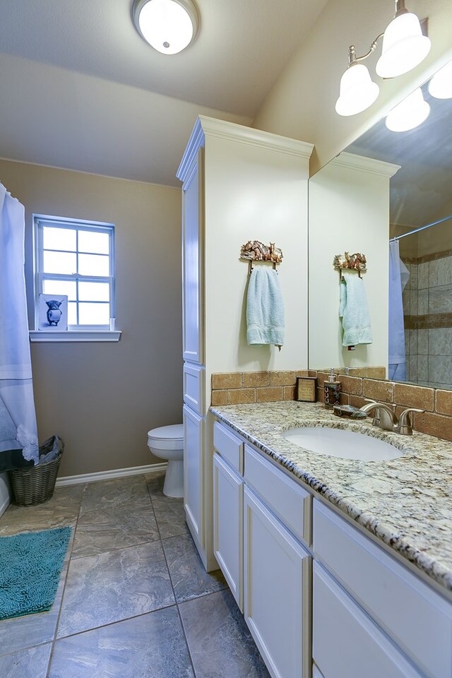 bathroom featuring vanity, a shower with shower curtain, and toilet