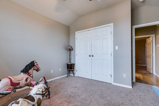 interior space with lofted ceiling and carpet