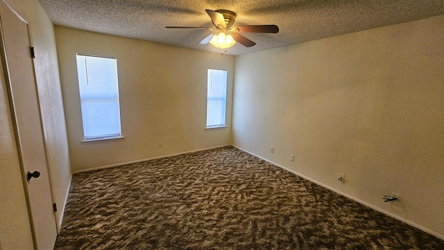 carpeted spare room featuring ceiling fan, plenty of natural light, and a textured ceiling