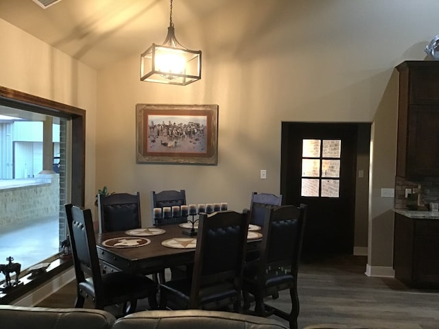 dining room featuring lofted ceiling and hardwood / wood-style floors