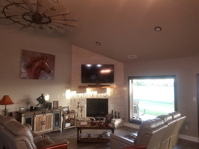 living room featuring hardwood / wood-style flooring, lofted ceiling, and a fireplace