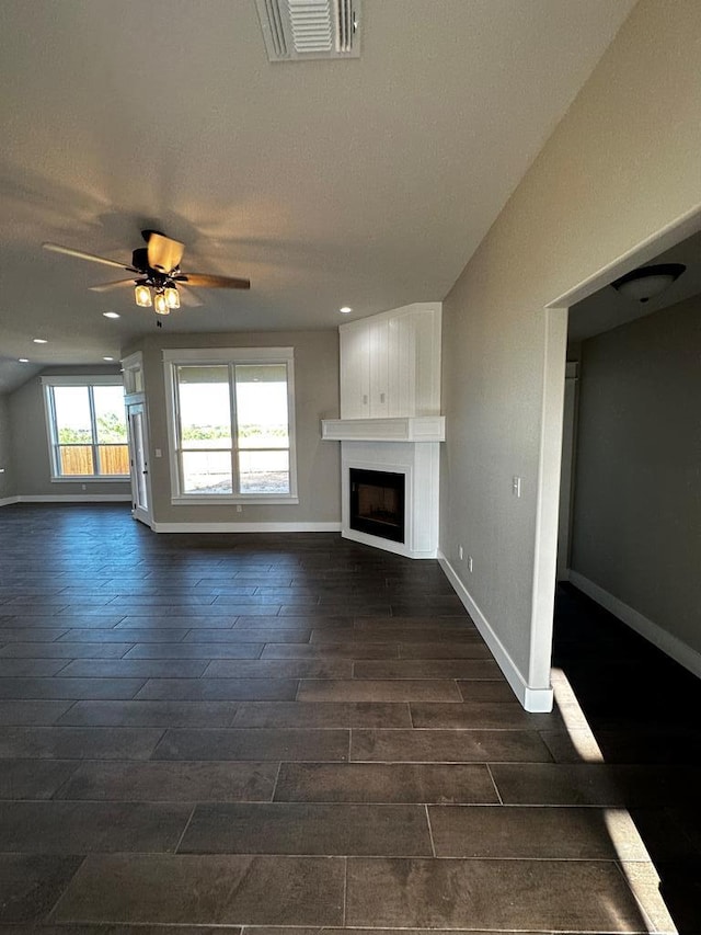 5610 Slayde St, San Angelo, TX 76904 - unfurnished living room with a large fireplace, baseboards, ceiling fan, and recessed lighting