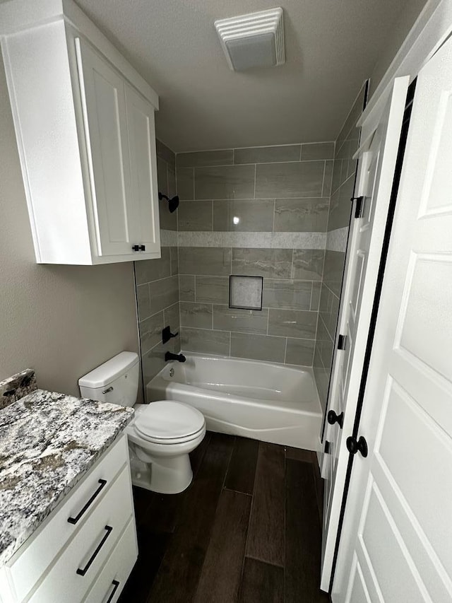 5610 Slayde St, San Angelo, TX 76904 - full bath featuring toilet, wood finished floors, vanity, and shower / bath combination