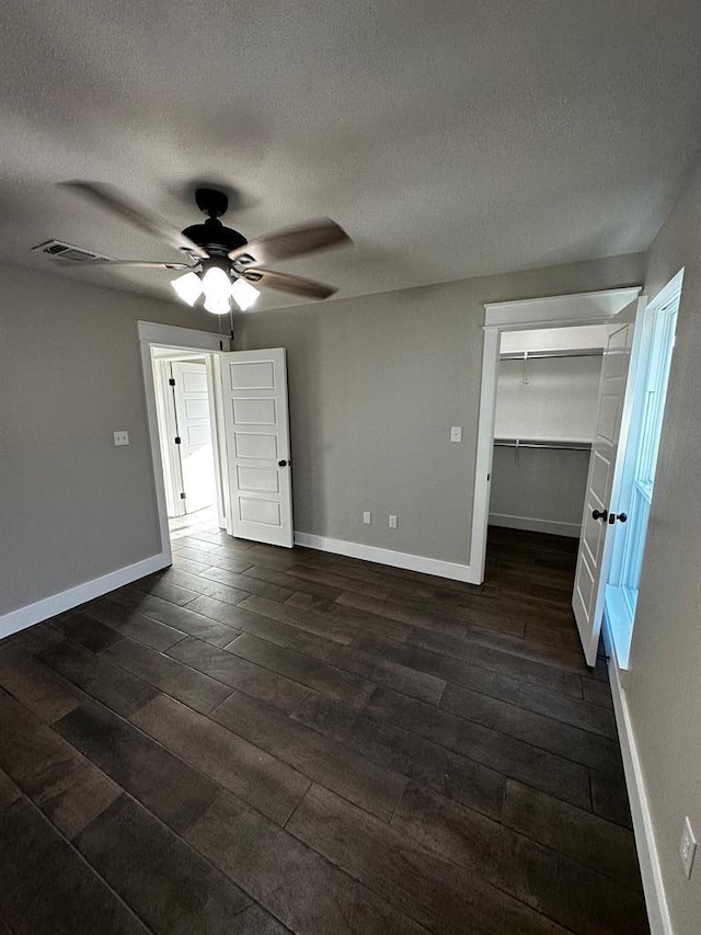 5610 Slayde St, San Angelo, TX 76904 - unfurnished room with dark wood-type flooring, ceiling fan, a textured ceiling, and baseboards