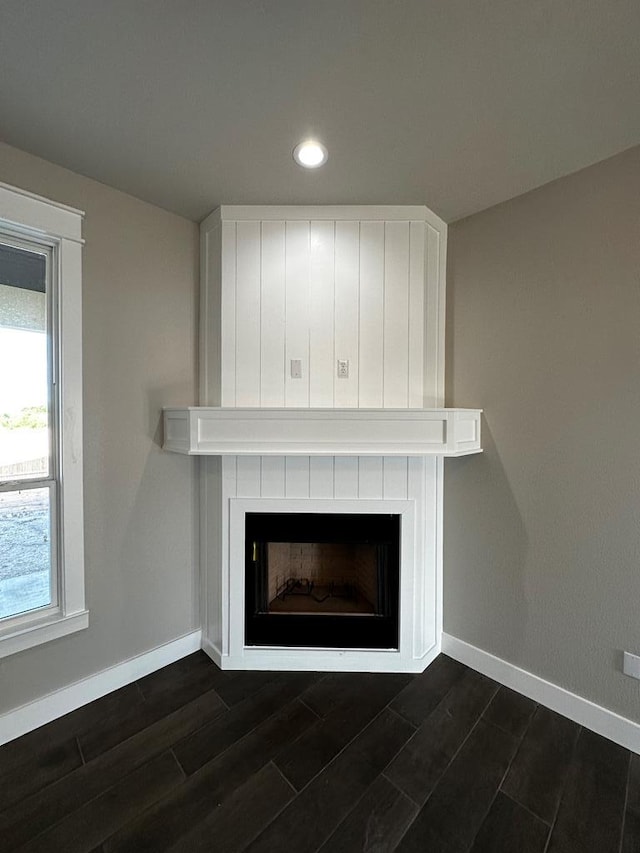 5610 Slayde St, San Angelo, TX 76904 - detailed view of a fireplace, wood finished floors, recessed lighting, and baseboards