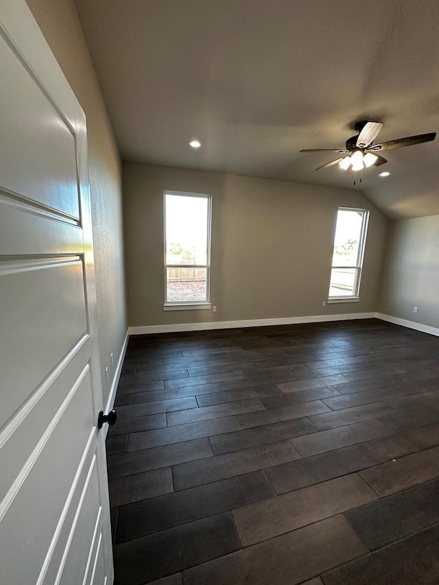 5610 Slayde St, San Angelo, TX 76904 - unfurnished room featuring plenty of natural light, dark wood-style floors, baseboards, lofted ceiling, and recessed lighting