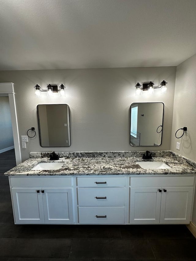 5610 Slayde St, San Angelo, TX 76904 - bathroom with double vanity and baseboards