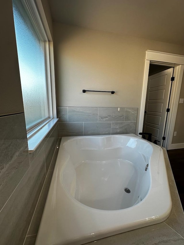 5610 Slayde St, San Angelo, TX 76904 - full bathroom with a garden tub and tile walls