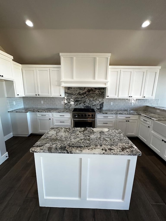 5610 Slayde St, San Angelo, TX 76904 - kitchen featuring high end stainless steel range, stone countertops, white cabinets, tasteful backsplash, and recessed lighting
