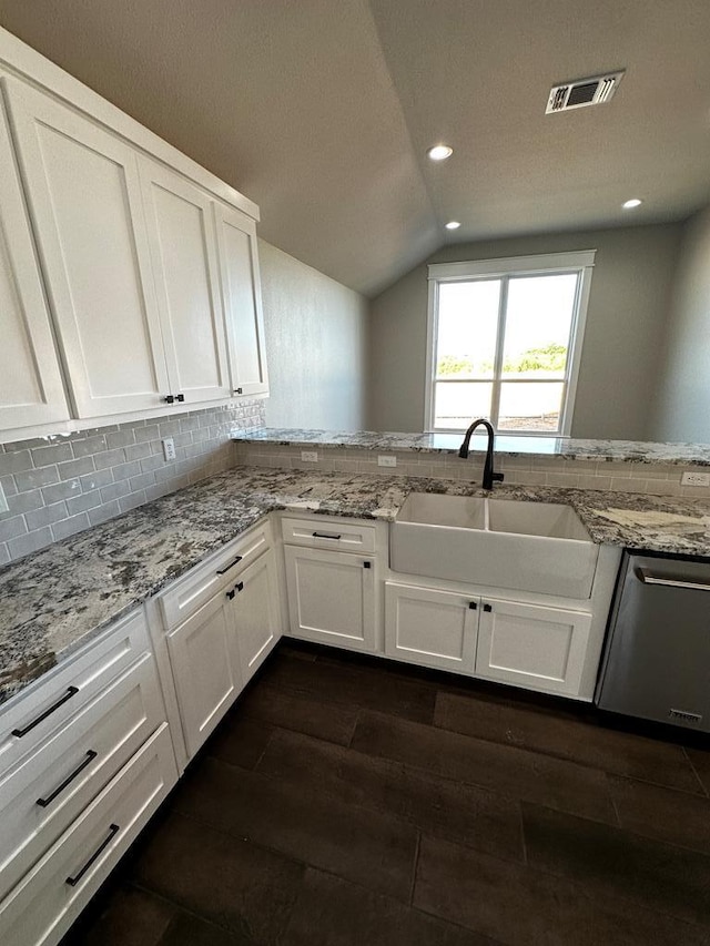 5610 Slayde St, San Angelo, TX 76904 - kitchen with dishwasher, vaulted ceiling, white cabinetry, a sink, and dark wood finished floors