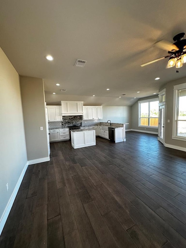 5610 Slayde St, San Angelo, TX 76904 - kitchen featuring open floor plan, baseboards, dark wood finished floors, white cabinets, and recessed lighting