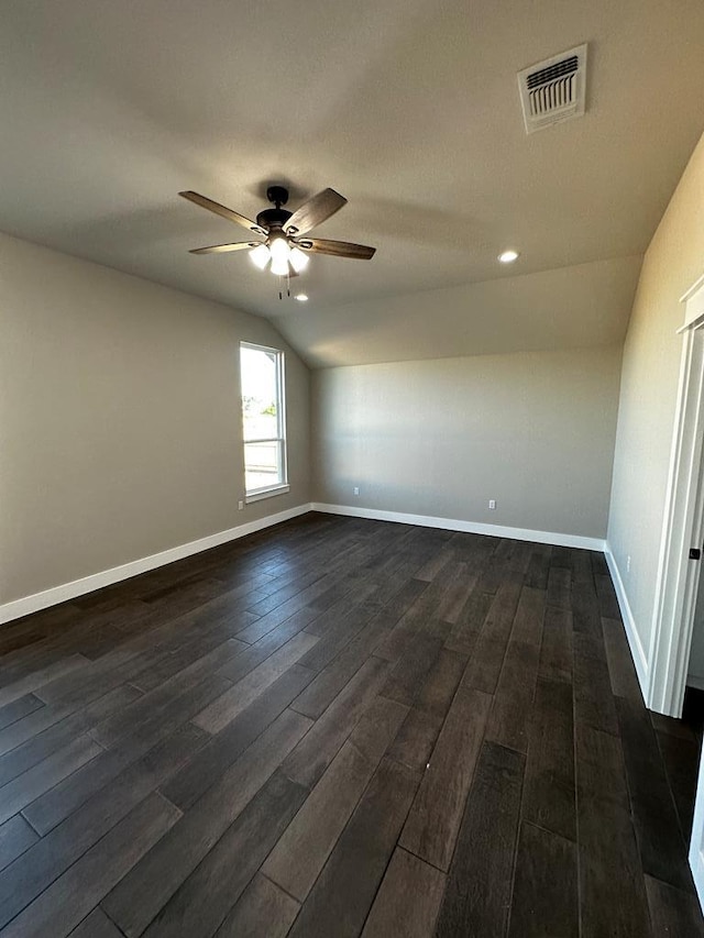 5610 Slayde St, San Angelo, TX 76904 - spare room featuring ceiling fan, dark wood-style floors, vaulted ceiling, and baseboards