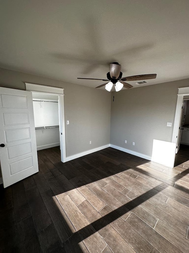 5610 Slayde St, San Angelo, TX 76904 - unfurnished bedroom featuring dark wood finished floors, baseboards, and a closet