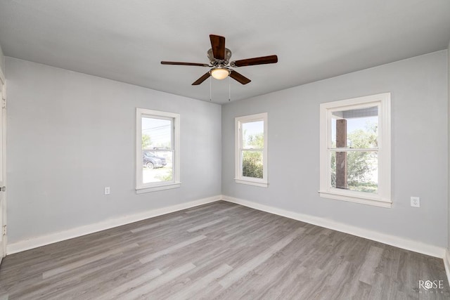 empty room featuring ceiling fan and light wood-type flooring