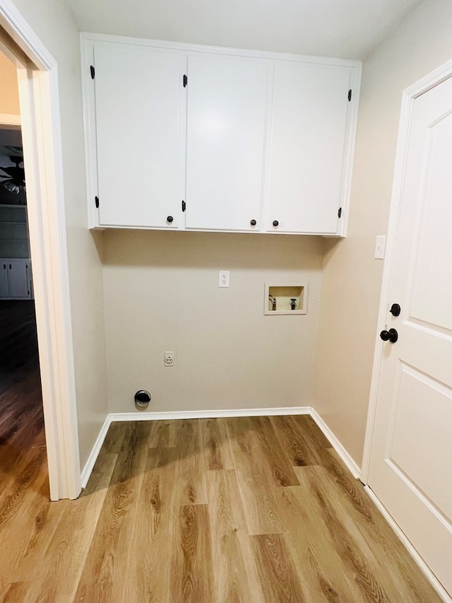 clothes washing area with hookup for a washing machine, hookup for an electric dryer, cabinets, and light hardwood / wood-style flooring