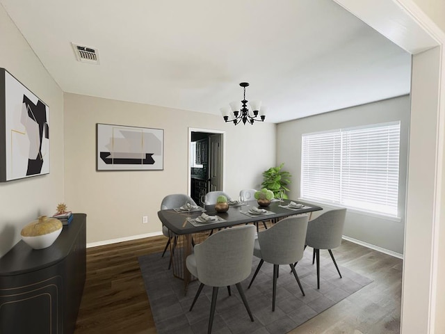 dining space featuring wood-type flooring and a notable chandelier