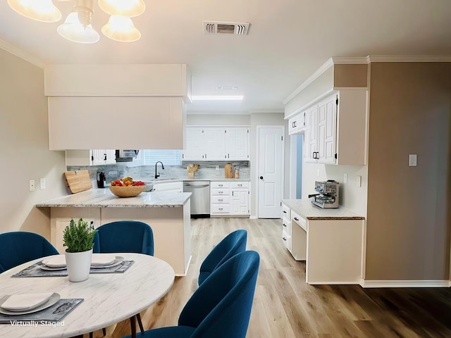 kitchen with white cabinetry, kitchen peninsula, sink, dishwasher, and crown molding