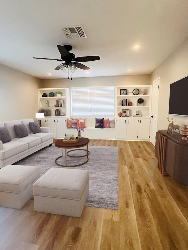 living room with built in features, ceiling fan, and light hardwood / wood-style flooring