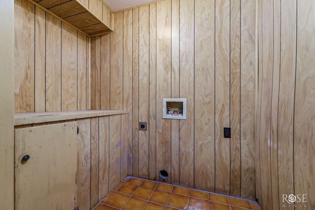 clothes washing area featuring hookup for a washing machine, electric dryer hookup, and wooden walls