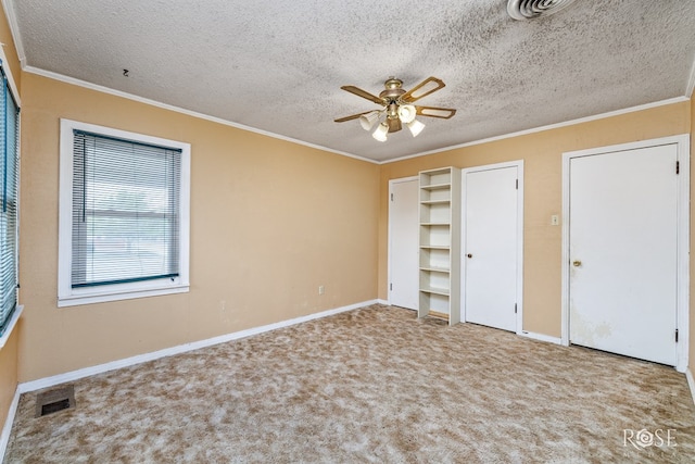 unfurnished bedroom featuring crown molding, ceiling fan, light carpet, and a textured ceiling